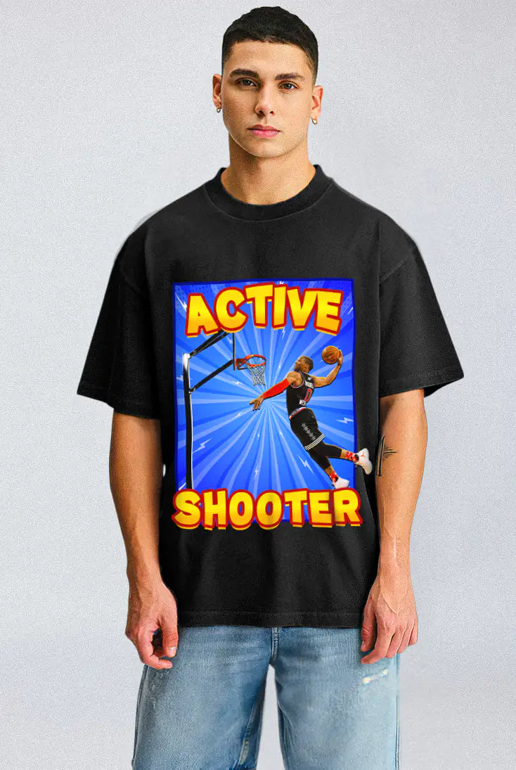 Person wearing a black t-shirt with a colorful graphic and text on a light gray background