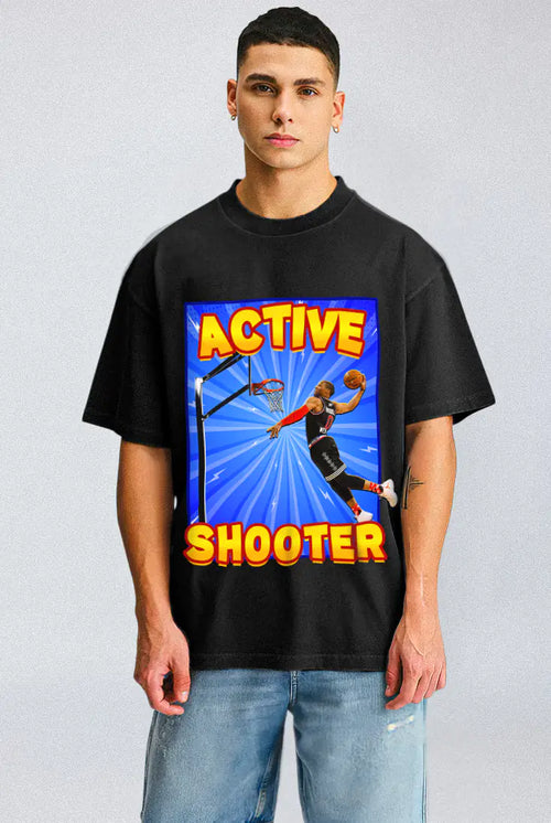 Person wearing a black t-shirt with a colorful graphic and text on a light gray background